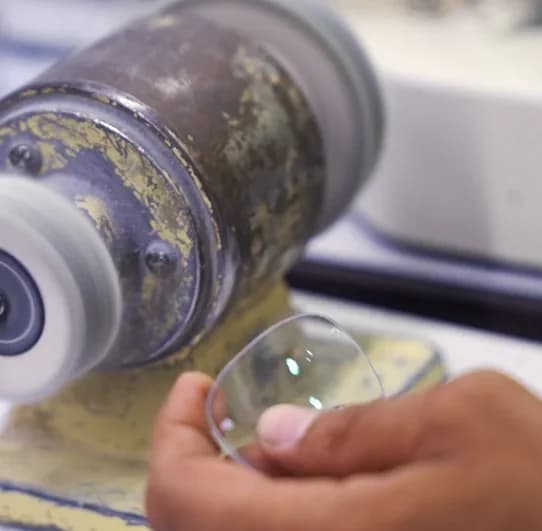 A lens edge being ground on the wheel